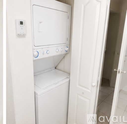A white washing machine and dryer in a small laundry room.