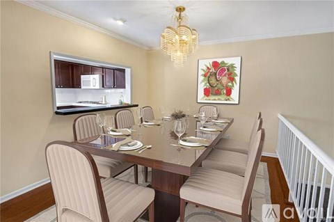 A dining room with a long table set for six people.