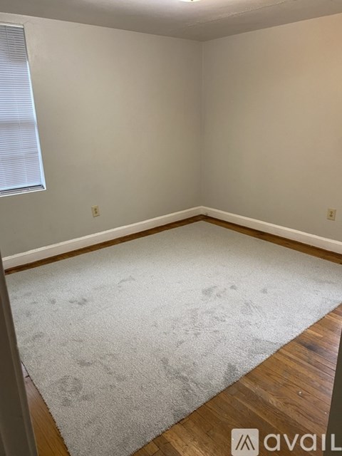 A room with a carpet and wooden floor.
