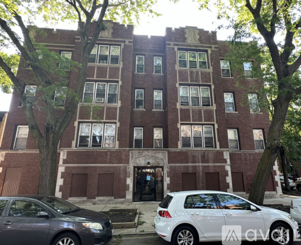 A brick building with a white car parked in front.