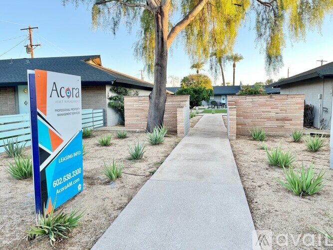 A sign for Acora Asset Management is in front of a building.
