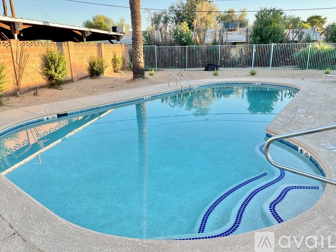 A small pool with a metal fence around it.