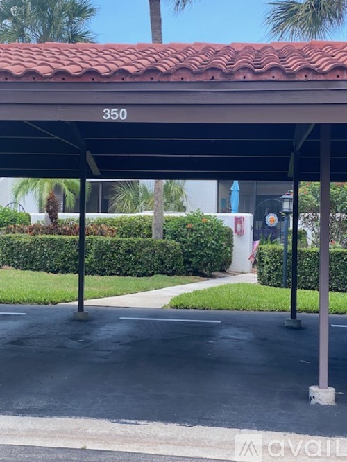 A covered parking area with the number 350 on the roof.