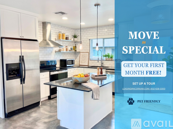 A modern kitchen with a refrigerator, microwave, and stove top oven.