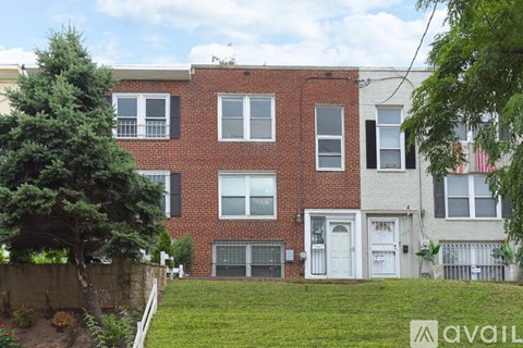 A red brick house with a white door and windows.