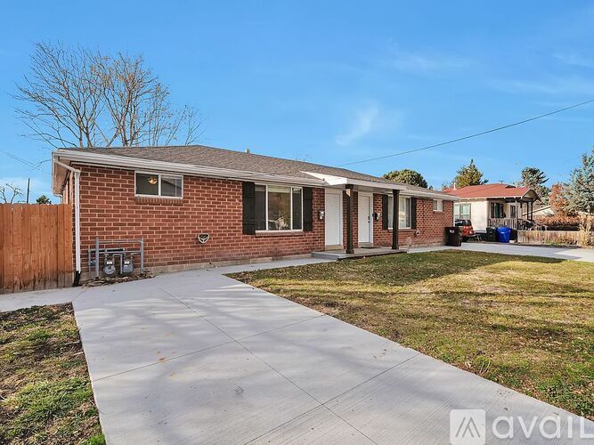 A house with a brick exterior and a white door is for sale.