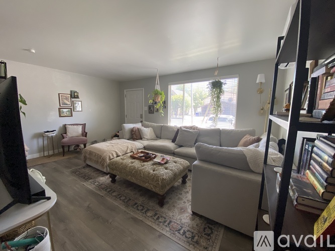 A living room with a couch, a chair, and a rug.