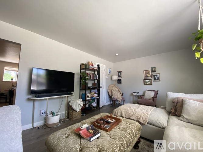 A living room with a television, a couch, and a coffee table.