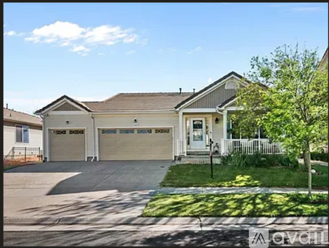 A two-story house with a garage and a driveway.
