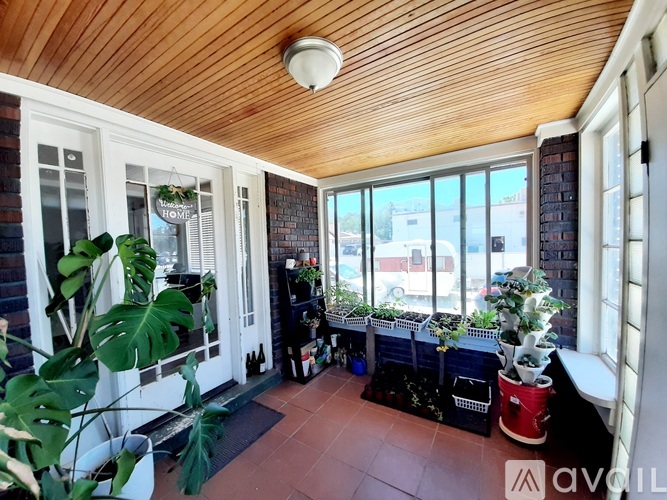 A balcony with a wooden ceiling and a sign that says "HOME".