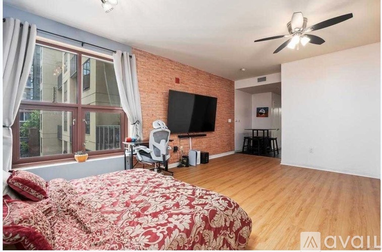 A bedroom with a large bed and a flat screen TV.