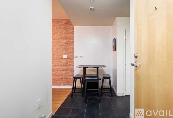 A dining area with a brick wall and a wooden door.