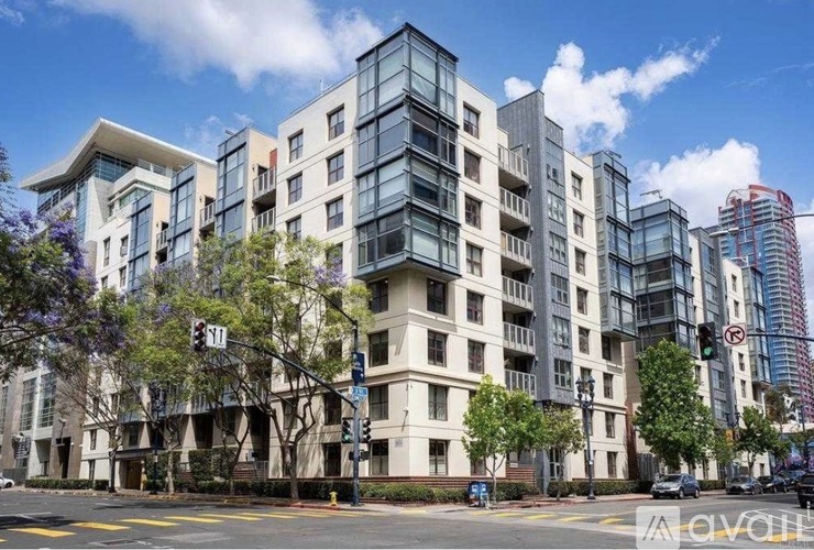 A modern apartment building with a mix of beige and blue tones.