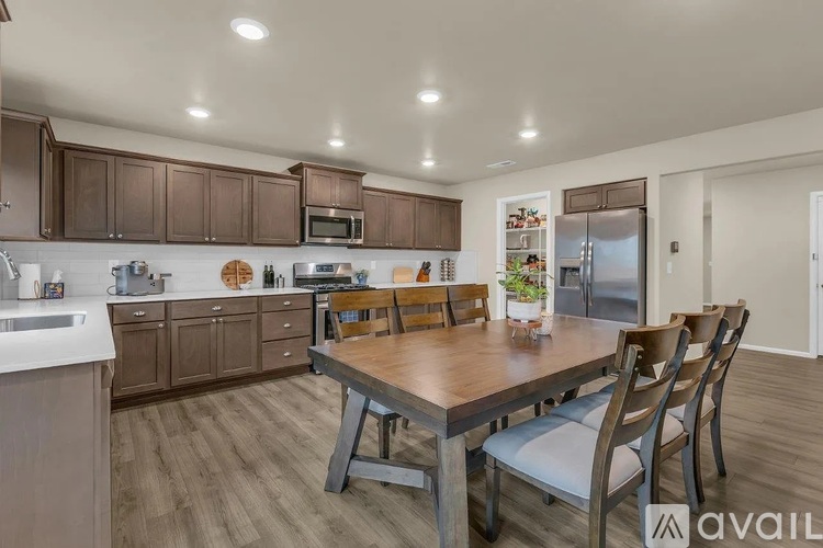 A kitchen with a table and chairs in the middle of the room.