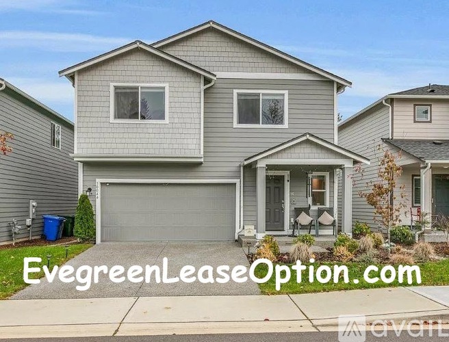 A house with the text "EvegreenLeaseOption.com" on the front yard.