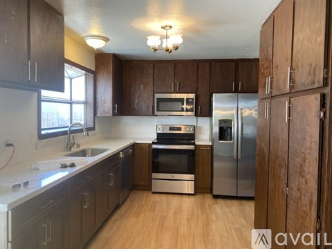 A kitchen with wooden cabinets and stainless steel appliances.