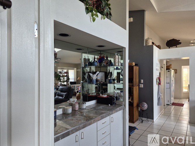 A modern kitchen with white cabinets and a large island.