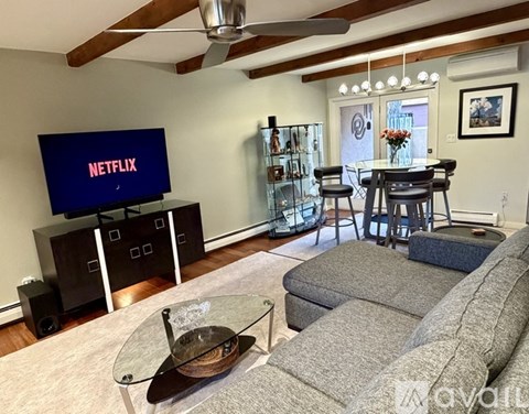 A living room with a Netflix screen on a stand.