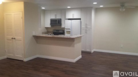 A kitchen area with a counter and cabinets.