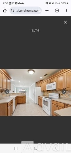 A kitchen with wooden cabinets and a white refrigerator.