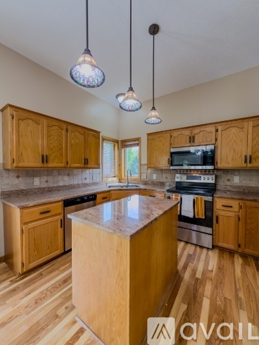 A kitchen with wooden cabinets and a central island.