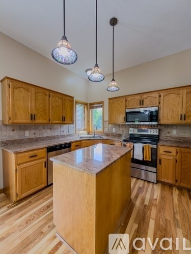 A kitchen with wooden cabinets and a central island.