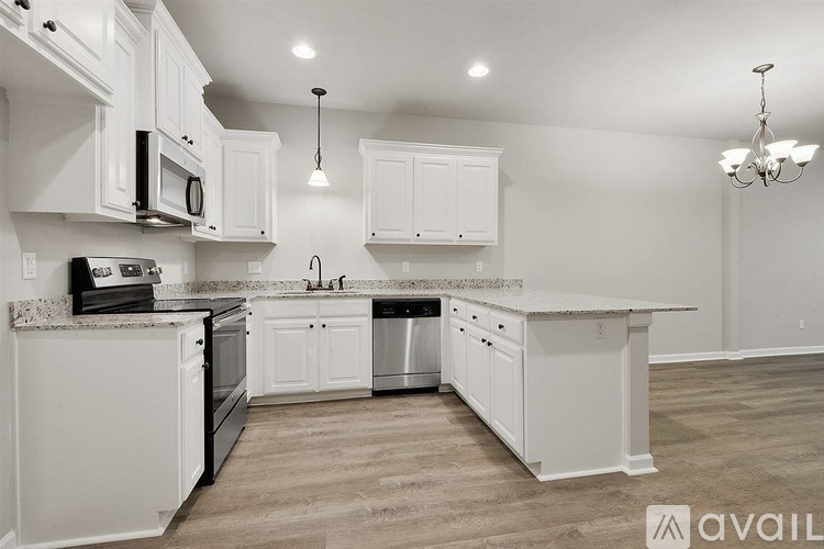A kitchen with white cabinets and appliances.