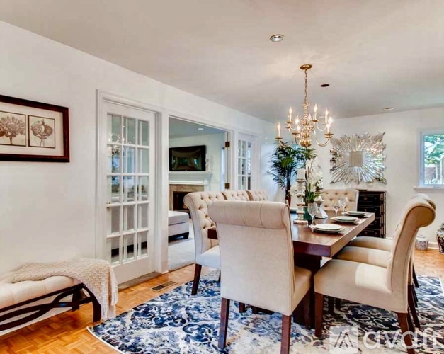 A dining room with a wooden table and chairs.
