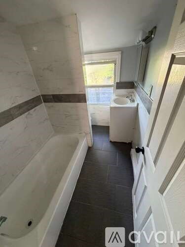 A bathroom with a tub and a sink.