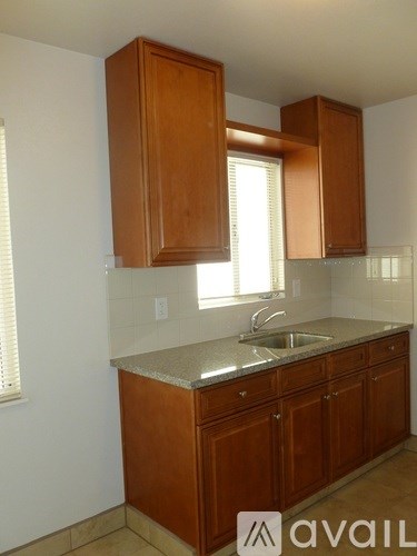 A kitchen with brown cabinets and a sink.