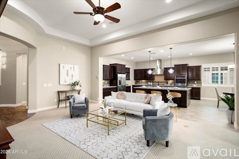 A living room with a white couch and a coffee table in the center.