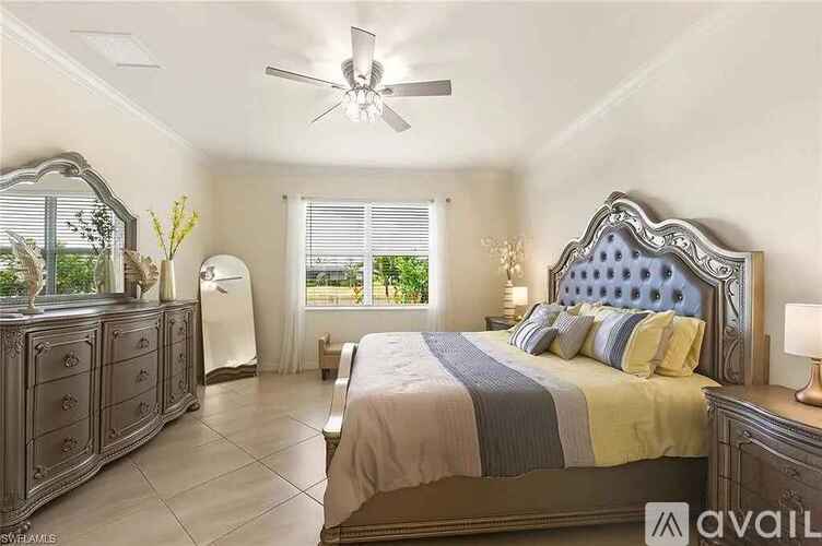 A bedroom with a large bed and a dresser with a mirror.