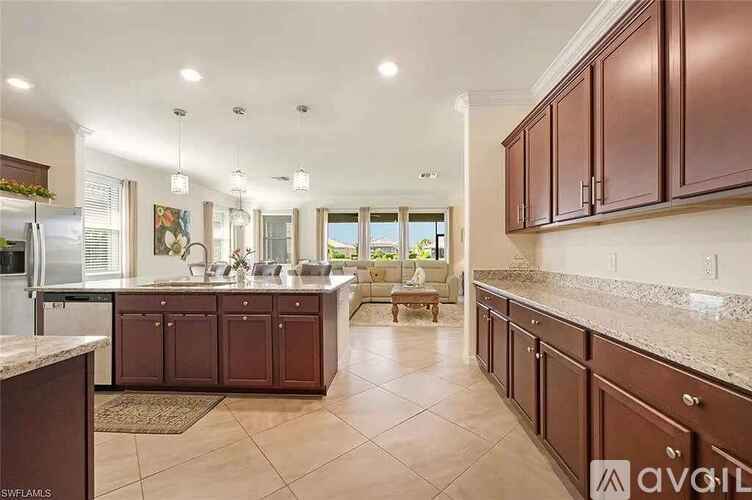 A kitchen with brown cabinets and a tiled floor.