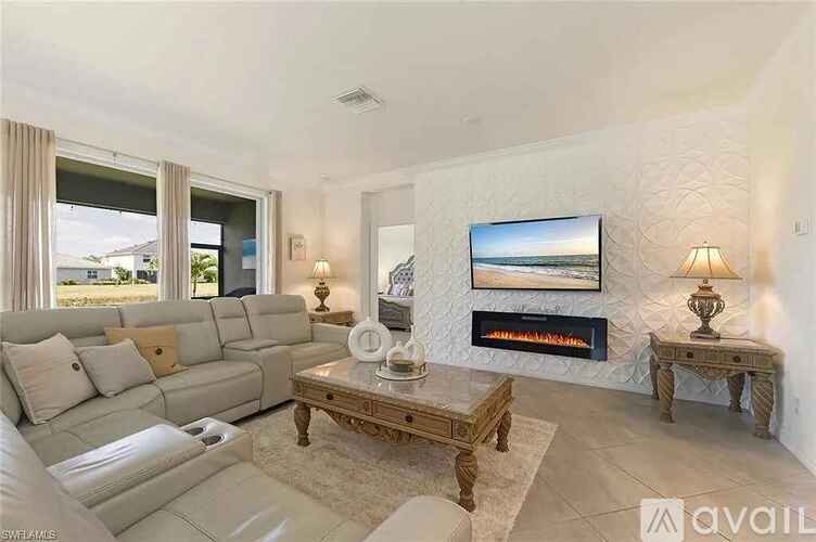 A living room with a fireplace and a painting on the wall.