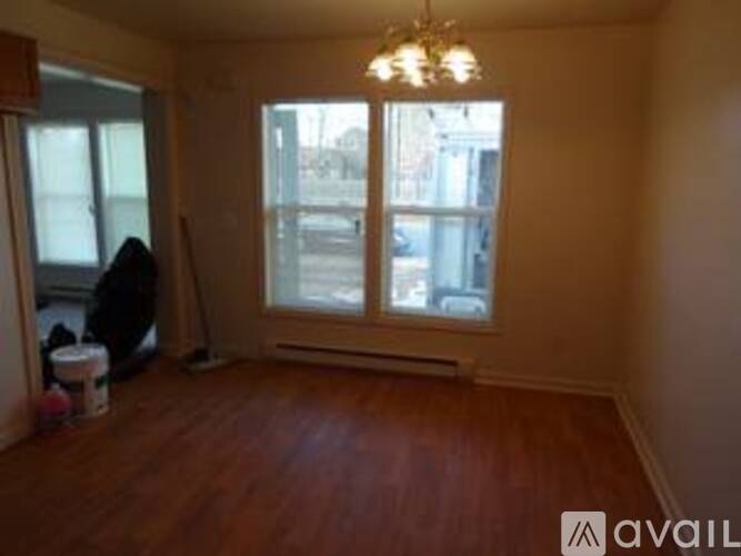 A room with wooden floors and a chandelier.