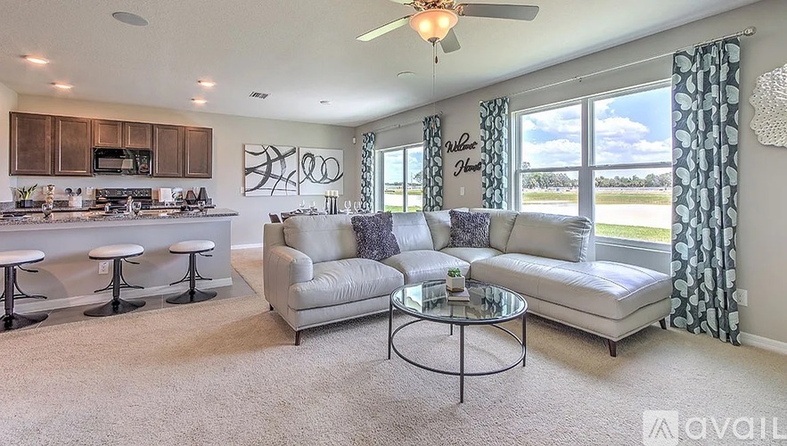 A living room with a couch, chair, and a coffee table.