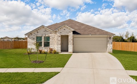 A house with a garage and a driveway in front of it.