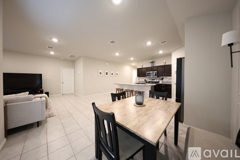 A modern living room with a wooden dining table and chairs.