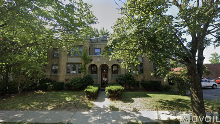 A building with a green lawn in front.