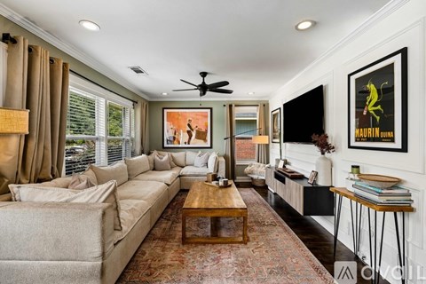 A living room with a couch, a coffee table, and a painting on the wall.