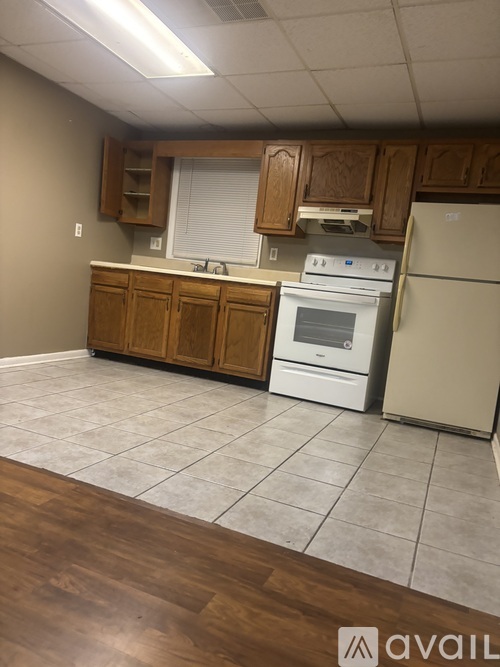 A kitchen with wooden cabinets and white appliances.
