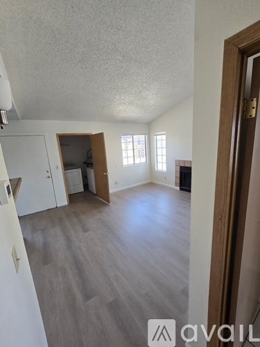 A kitchen with wooden cabinets and a white fridge.
