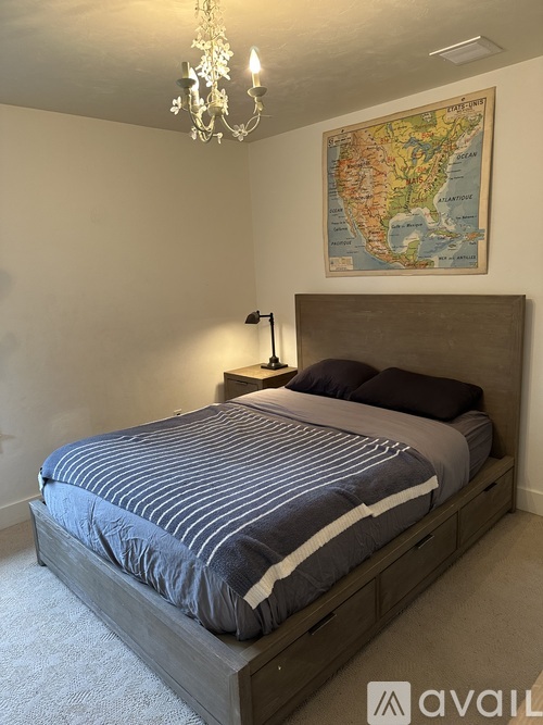 A bedroom with a large bed and a world map on the wall.
