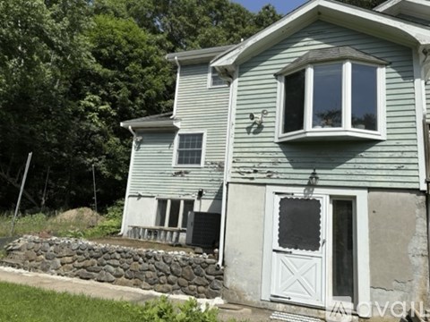 A house with a grey exterior and a white door.