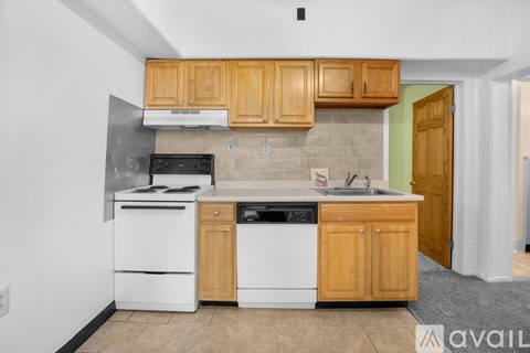 A kitchen with wooden cabinets and white appliances.