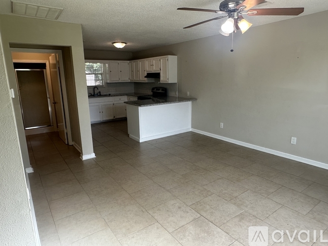 A kitchen with a fan on the ceiling and a countertop.