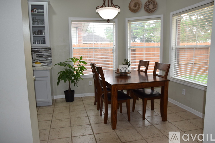 A dining room with a wooden table and chairs.
