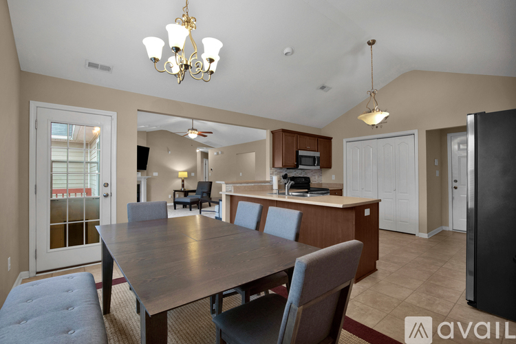 A dining room with a wooden table and chairs.