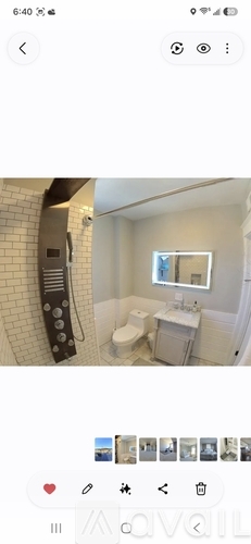 A bathroom with a toilet, sink, and mirror.