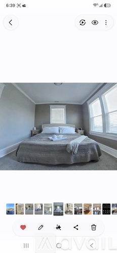 A bedroom with a bed and a window.